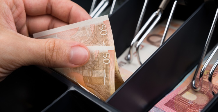 Hand taking cash out of a cash register; copyright: Superdata...