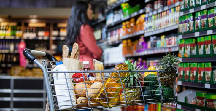 Shopping cart filled with groceries in a supermarket; copyright:...