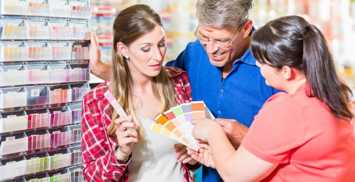 A saleswoman advises a couple on colour selection; copyright:...