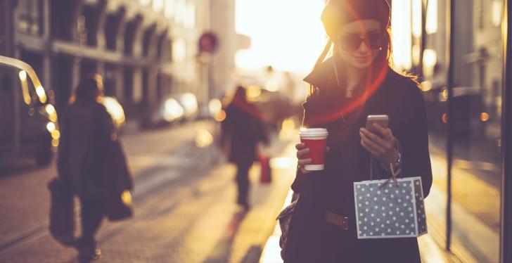 Woman on the street with smartphone in her hand