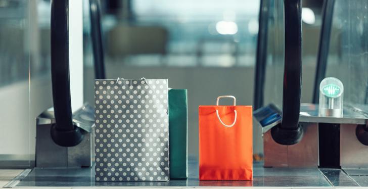 Two shopping bags standing on the top of a moving staircase; copyright:...