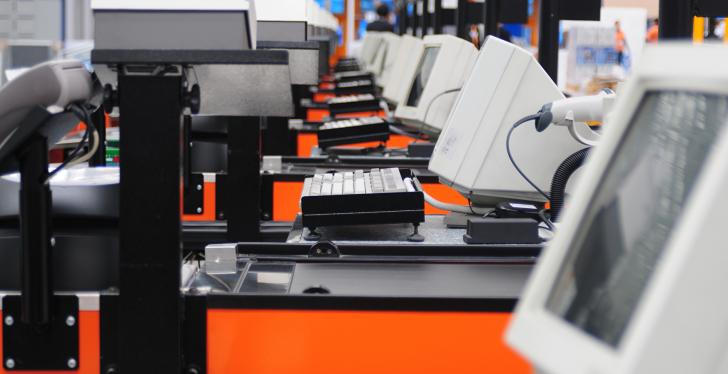 A long row of cash registers with monitors and other devices; copyright:...