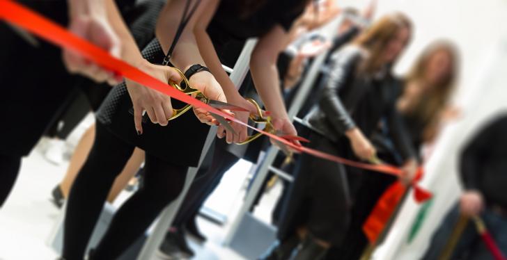 Several people cutting through a red ribbon; copyright: panthermedia.net/ronstik...