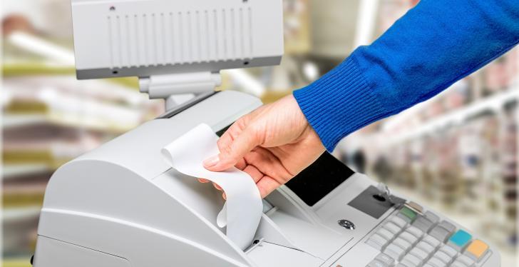 Woman taking a receipt from a cash register