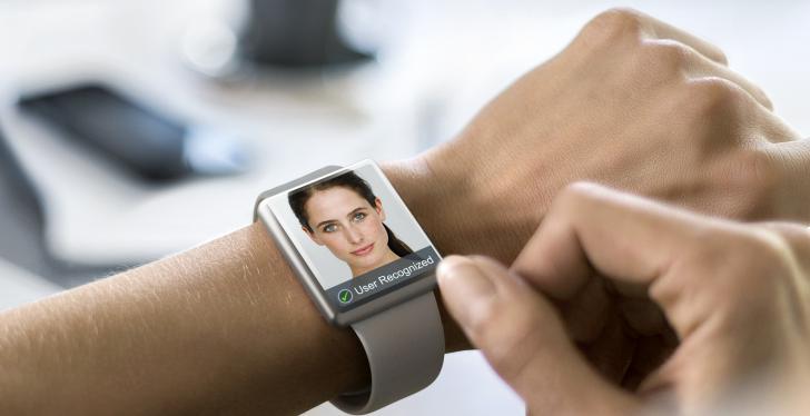 Smart watch on an arm with a human face on the display; copyright: Osram...