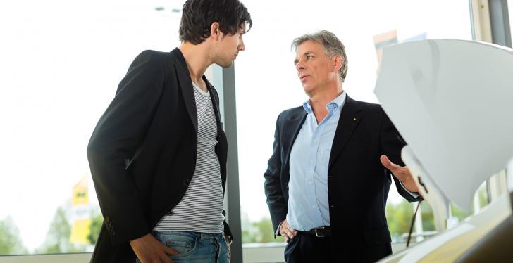 A salesman offers a car