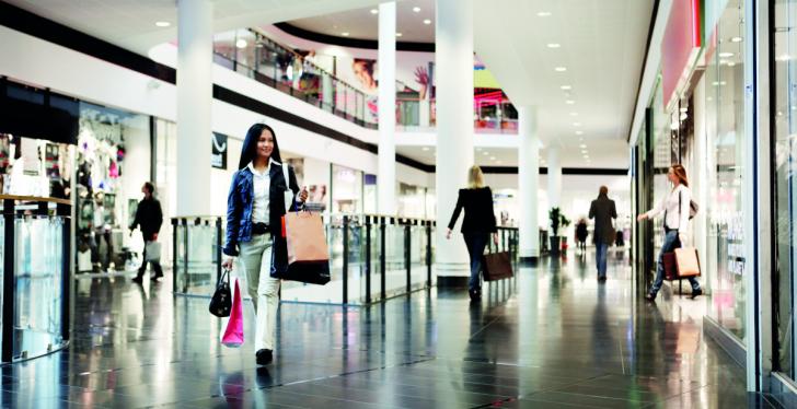 People walking through a shopping mall while shopping...