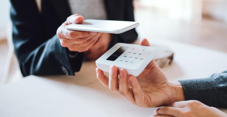 Someone paying with a smartphone