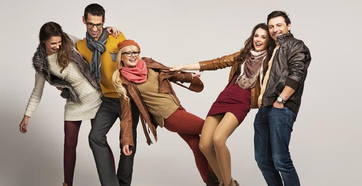 Young teenagers male and female in hip clothes standing together having fun...