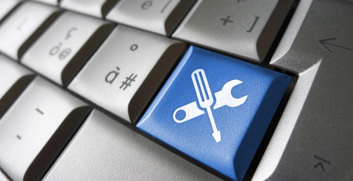 A grey keypad with a blue key with symbols of tools on it...