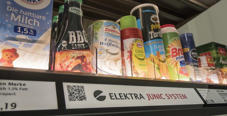 Shelf board in the supermarket with food and a digital shelf sign underneath....