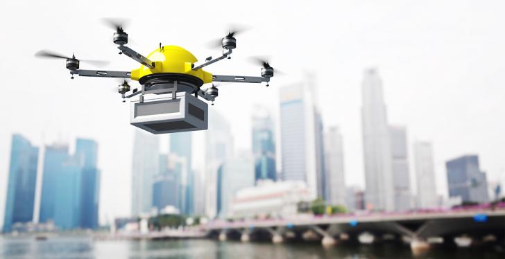 A delivery drone over water in front of skyscrapers...