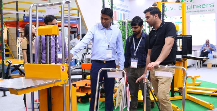 A guy showing a machine to two men