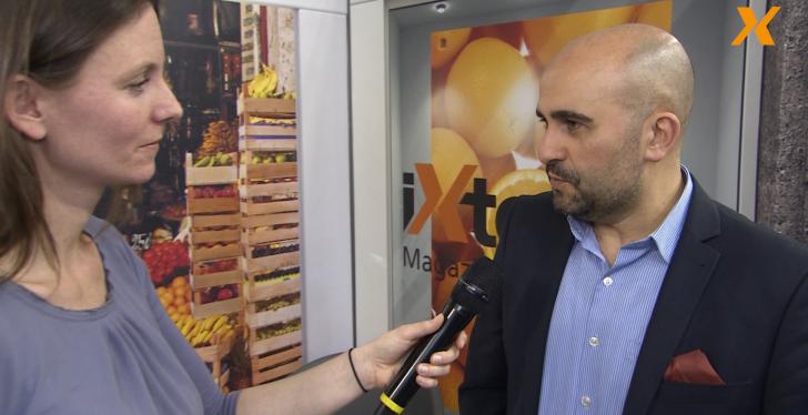 A woman interviews a man in a suit