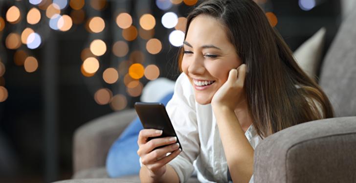 Woman shops mobile from her couch