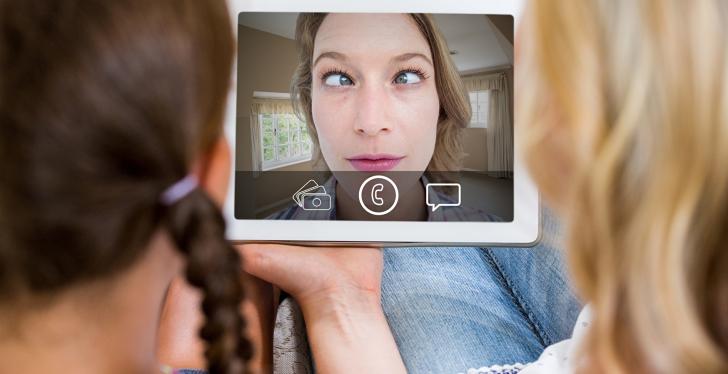 Wife and daughter watching video message on a tablet....