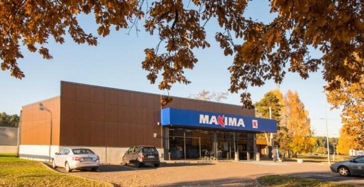 A supermarket branch from outside between autumnally coloured trees...