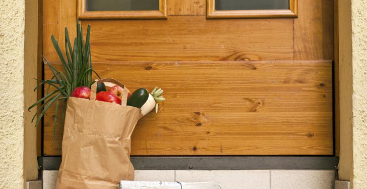 fresh groceries standing in front of a door