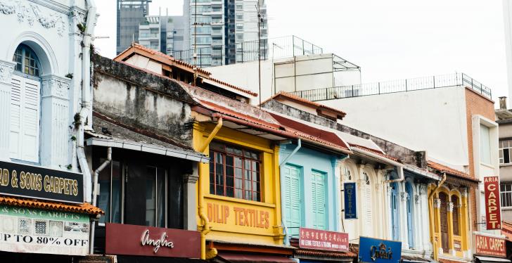 Several store fronts in different houses in a city