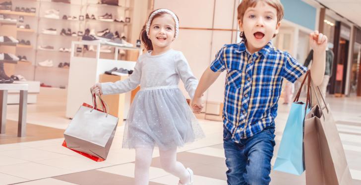 Children walk hand in hand through the shopping center...