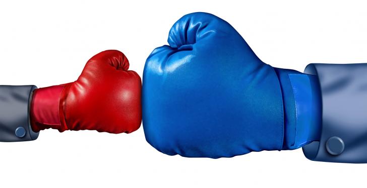 A small red boxing glove against a big blue boxing glove...