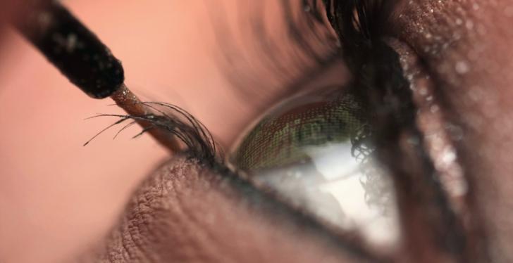 Close up of a woman’s eye applying make-up