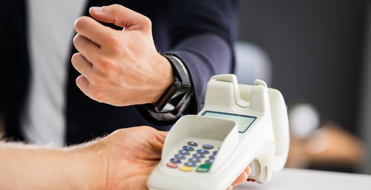 Someone is holding a smartwatch close to a payment device...