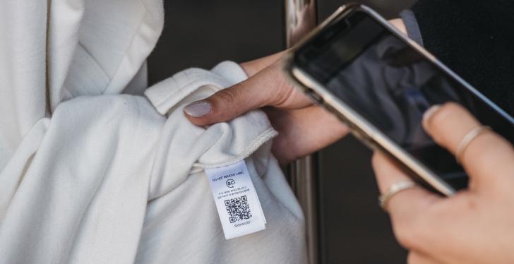 smartphone scans qr-code on t-shirt label