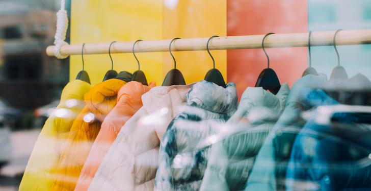 colorful jackets hang on a clothes rail