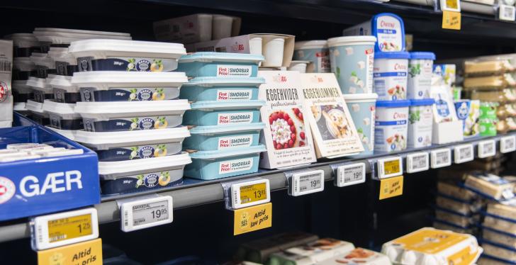 A full grocery shelf with individual electronic shelf labels communicating...