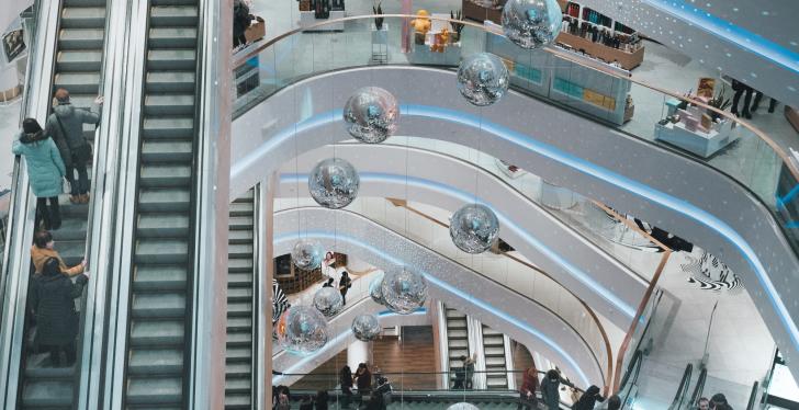 Inside view of a shopping mall with multiple levels and escalators...