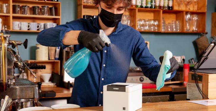 a man cleaning a POS-printer; Copyright: Citizen Systems Europe...