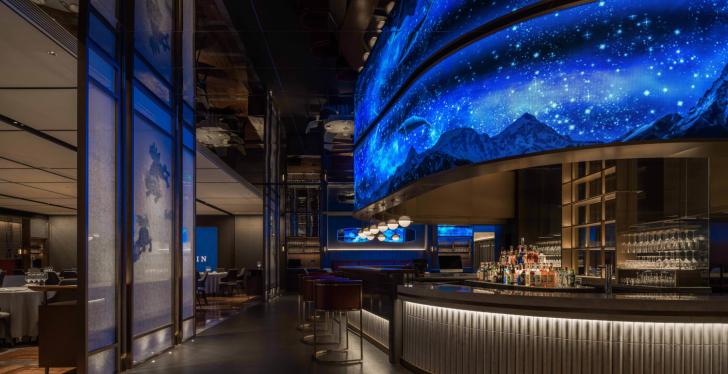Fish restaurant XU JI in Hangzhou, China, with a blue LED wall above the bar;...
