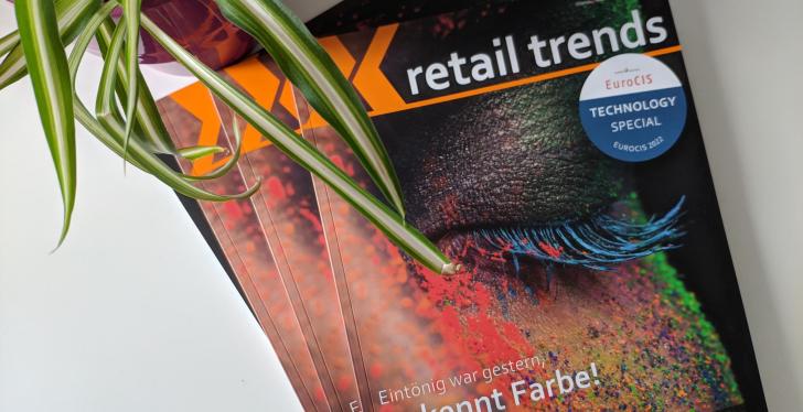 New retail trends magazines on a white background. Top left a green plant in a...