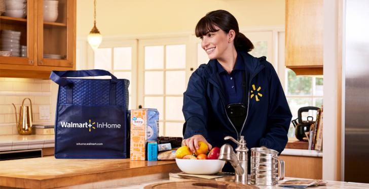 A walmart delivery woman standing in a customers kitchen with groceries:...