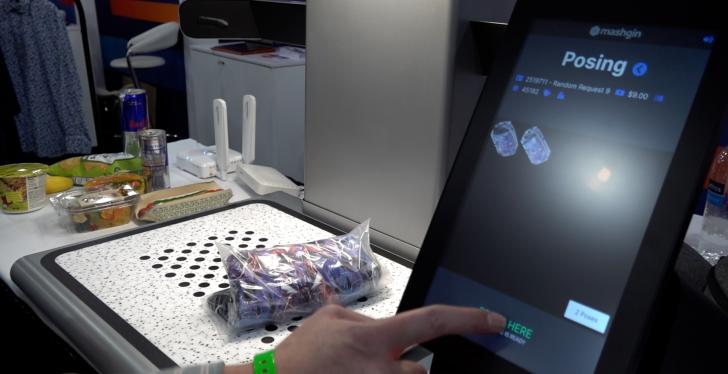 An item of clothing on a tray, getting scanned by a camera, beside a screen...