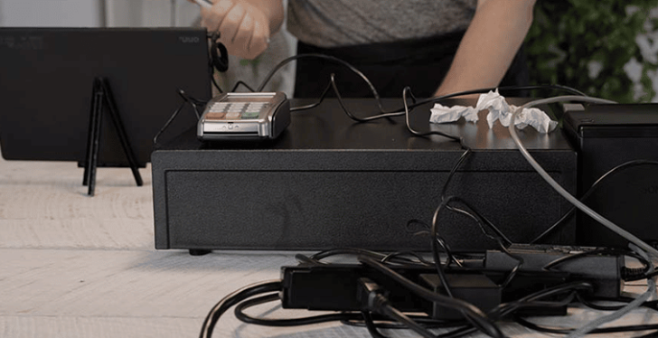 A cash desk with devices like a cash drawer, a payment device and a printer...