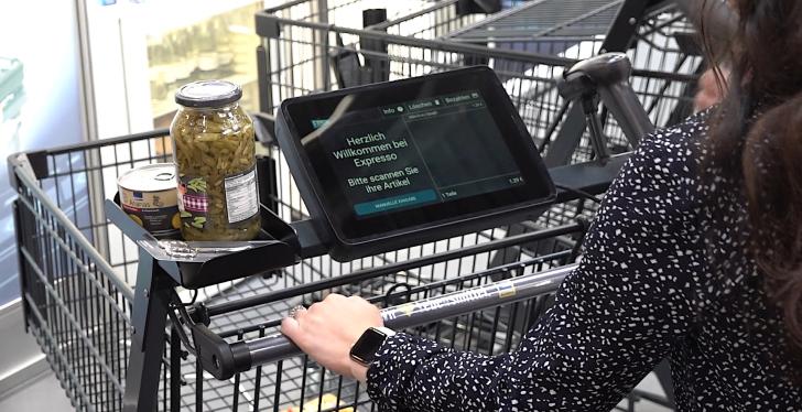 A person uses the Expresso SmartShopper at EuroCIS 2022...