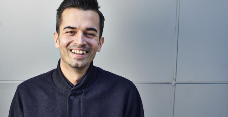 Fabio Adlassnigg, Head of Communications Wolt, smiles at the camera...