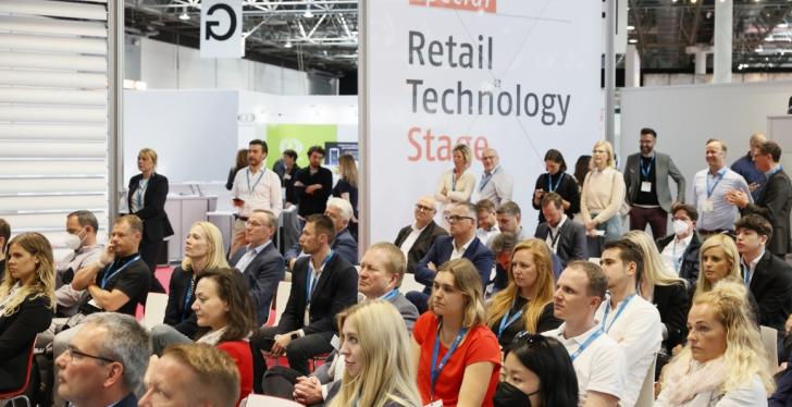 Many people at a lecture at the EuroShop trade fair, seated...
