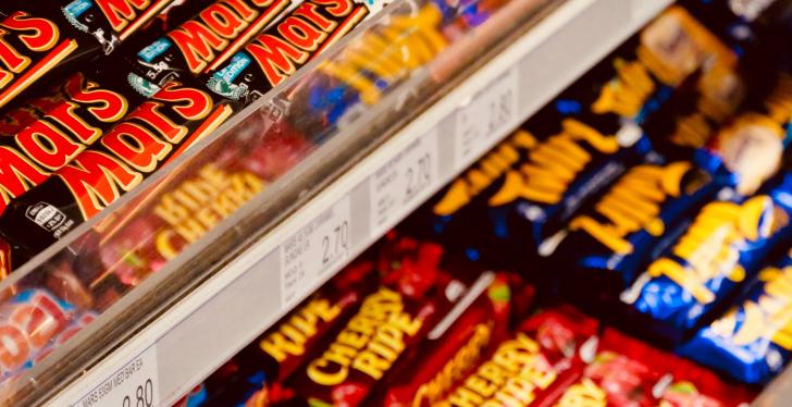 Candy bars on a shelf in a supermarket