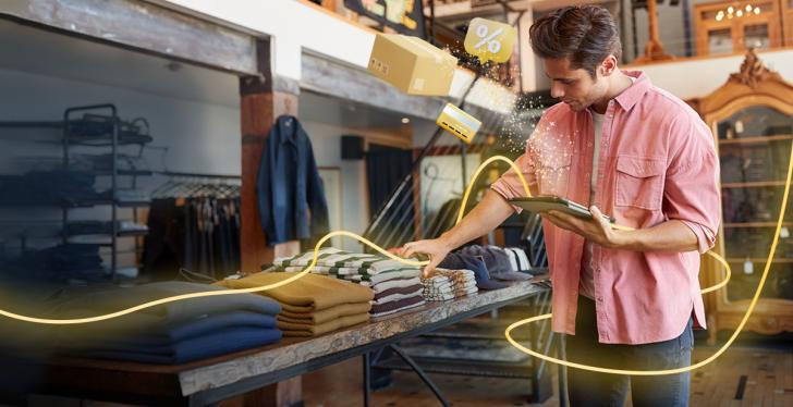 Person in fashion store with smartphone in hand