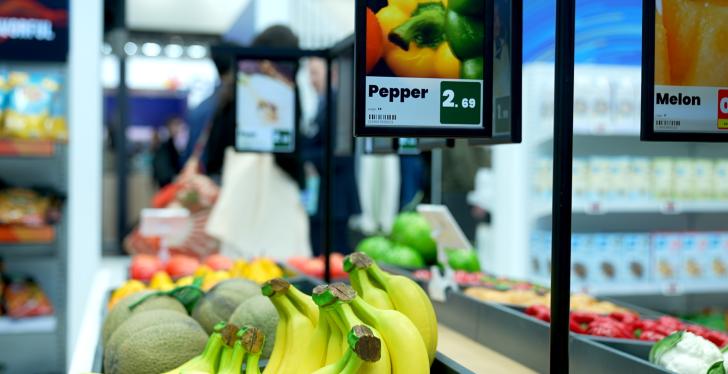 Fresh fruits like bananas and a digital pricing sign above; copyright. Hanshow...