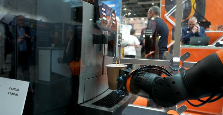 A robotic arm taking a coffee cup from a vending machine...