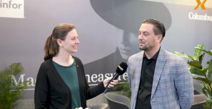 A woman interviews a man at a booth at EuroShop 2023...