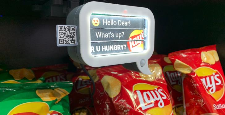A sign with the inscription Hello Dear. Whats up? R U Hungry? on a shelf of...