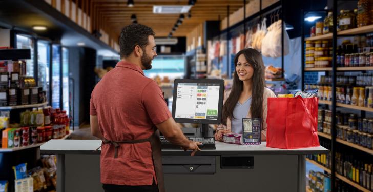 Two people at a sales counter in a retail shop