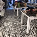 A tiled floor with black and white patterns in a shop...