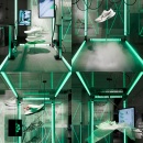 view into a modern black Nike store with green lamps and sports shoes...