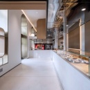 A modern style pastry store with curved arches and large windows...